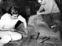 Bill Reid and Doug Cranmer carving the frontal board of Haida Mortuary pole, 1961