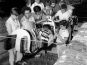 Ellen and Ted Neel and children carving a totem pole, 1955